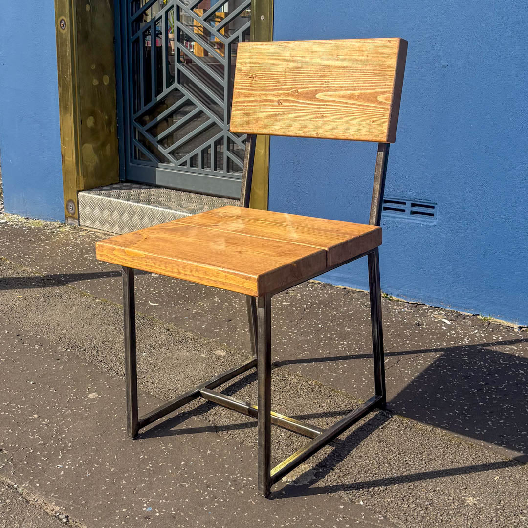 Rustic solid oak garden cube chair with a square seat and cantilever steel frame